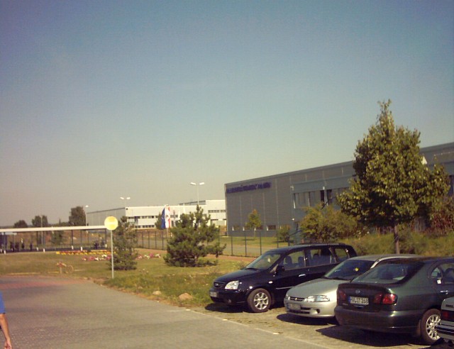 cars parking in front of an industrial building